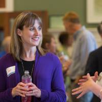 Staff members smiling and talking together.